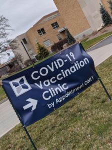 a vaccination clinic directional sign